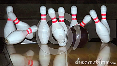 Bowling ball and falling pins Stock Photo
