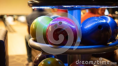 Brunswick bowling balls under UV light in bowling alley Editorial Stock Photo
