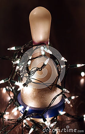 Bowling pin with Christmas lights strung around it Stock Photo