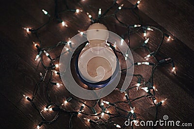 Bowling pin with Christmas lights strung around it Stock Photo