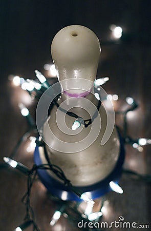 Bowling pin with Christmas lights strung around it Stock Photo