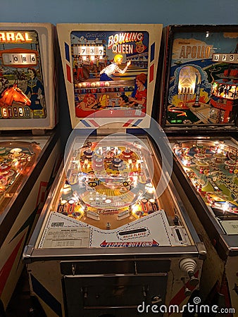 Bowling Queen pinball game flanked by Corral and Apollo Editorial Stock Photo