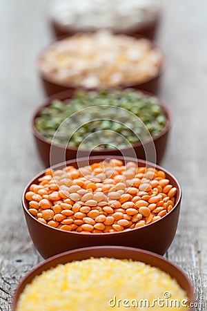 Bowls of cereal grains. Selective focus on red lentils. Stock Photo