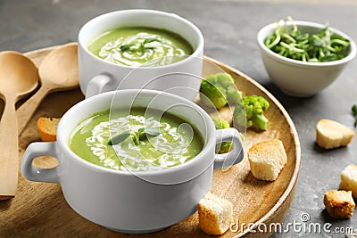 Bowls of delicious broccoli cream soup with microgreens Stock Photo