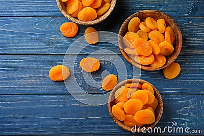 Bowls with dried apricots on wooden table Stock Photo