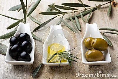 In the bowls extra virgin olive oil and organic olives Stock Photo