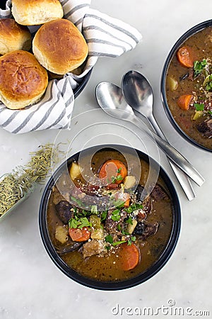 Bowls of Italian Beef Stew with Dinner Rolls Stock Photo