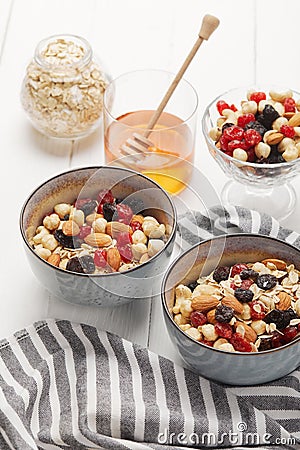 Bowls with muesli, dried berries and Stock Photo