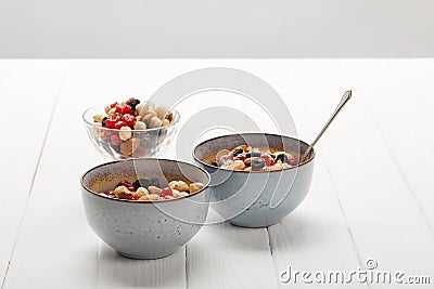 Bowls with muesli, dried berries and Stock Photo