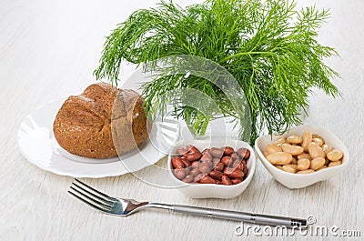 Bowls with red and white beans, bread, dill in glass Stock Photo