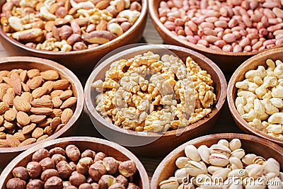 bowls of various mixed nuts on wooden background Stock Photo