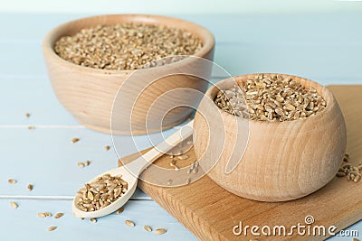 Bowls with wholegrain spelt farro on wooden table Stock Photo