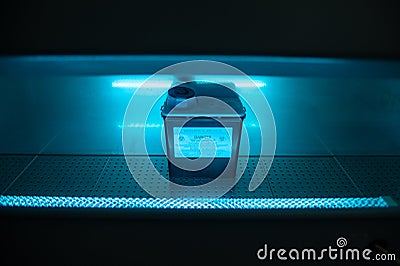 Box with danger virus content under UV ultraviolet light Stock Photo