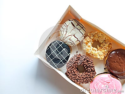A box of donuts with a variety of different toppings. sweet dessert Stock Photo