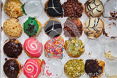 A box of doughnuts in various flavors and toppings Stock Photo