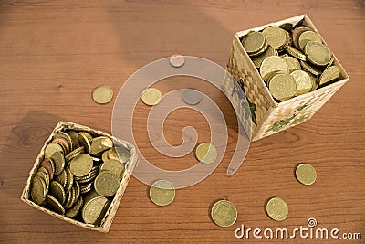 Box full of euro coins on a wood table Stock Photo