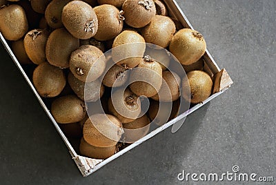 Box full of raw fresh kiwi fruits Stock Photo