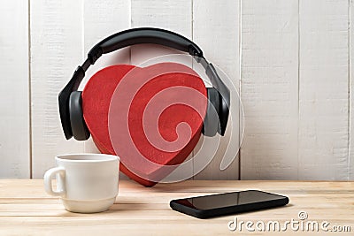 Box heart shape with headphones, phone and cup. Love music concept Stock Photo