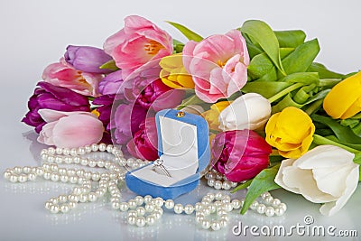 Box with luxury engagement ring and bouquet of tulips Stock Photo