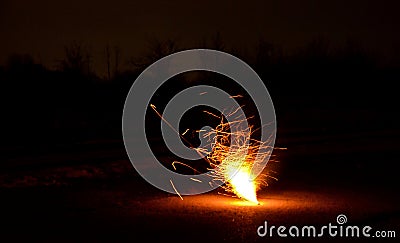 Box with night explosion full of explosive pyrotechnics. white orange fireball in the shape of a white bush with lots of hot shard Stock Photo