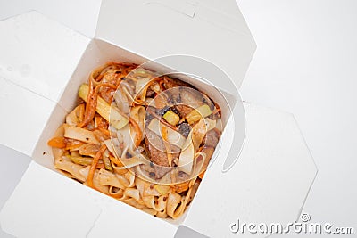 Box with noodles and pork. Opened take out box. Lunch food box Stock Photo