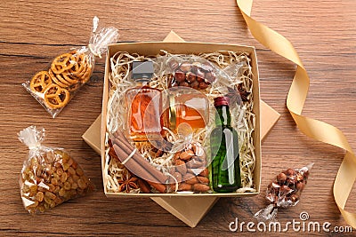 Box with stylish craft gift set on wooden table, flat lay Stock Photo