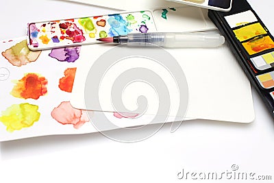 Box with watercolors, brush and palette on white paper background Stock Photo