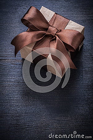 Boxed present tied bow on vintage wood board top view Stock Photo