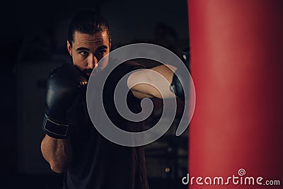 Boxer hitting the heavy bag with front jab Stock Photo