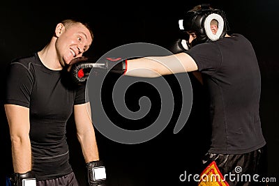 Boxer landing a punch on his opponents jaw Stock Photo