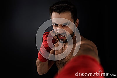 Boxer throwing a fierce and powerful punch. Stock Photo