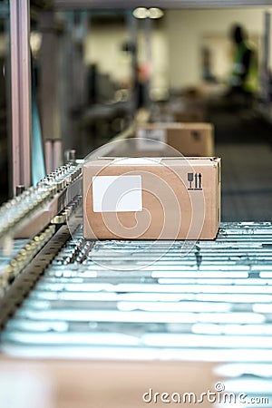 Parcel boxes on conveyer belt. Stock Photo