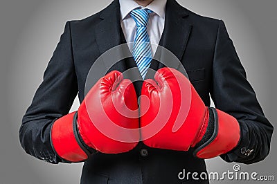 Boxing businessman with red gloves on gray background Stock Photo