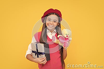 boxing day. kid in beret with toy. smiling child has birthday. teenage beauty go shopping. Stock Photo