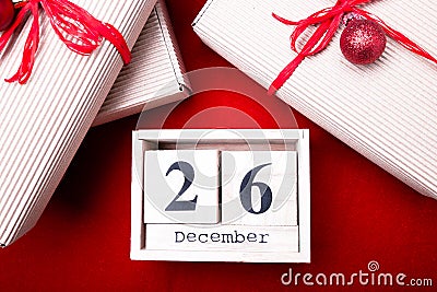 Boxing Day Sale. Calendar with date on red background. Christmas concept. December 26. Christmas ball and gifts. Top view. Copy sp Stock Photo