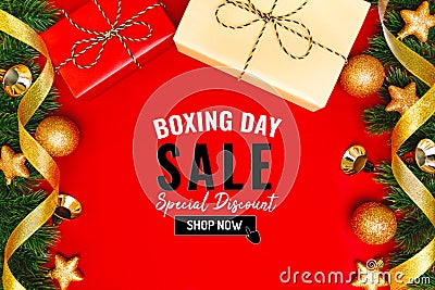 Boxing day sale with Christmas present and xmas decoration on red background Stock Photo