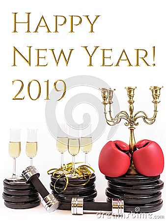 Boxing gloves and glasses of champagne on weight plates and dumbbells. Concept for new years resolution 2019 and workout Stock Photo