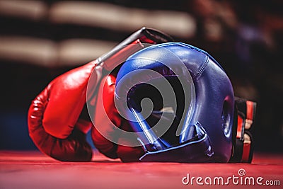 Boxing gloves and headgear in boxing ring Stock Photo