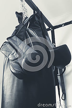 Boxing gloves and punching bag close-up sport concept black and white Stock Photo