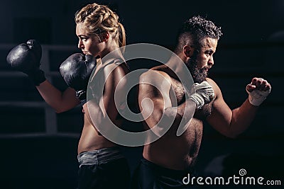 Boxing lessons concept. woman and man hold hands up in boxing gloves Stock Photo