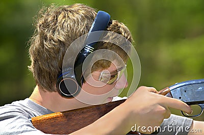 Boy Aiming Shotgun Stock Photo