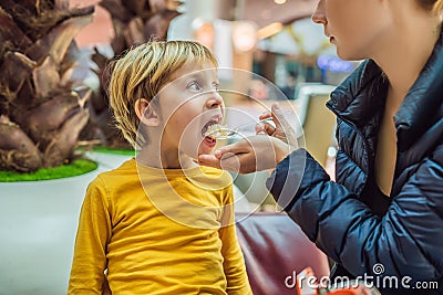 Boy at the airport - Young boy eating food while waiting for his flight Stock Photo