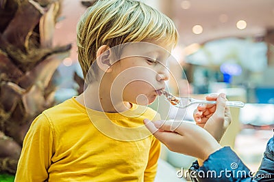 Boy at the airport - Young boy eating food while waiting for his flight Stock Photo