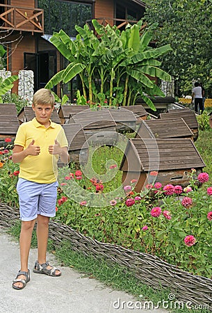 Boy at apiary on the road to lake Ritsa Stock Photo