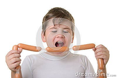 Boy with appetite bites sausages Stock Photo
