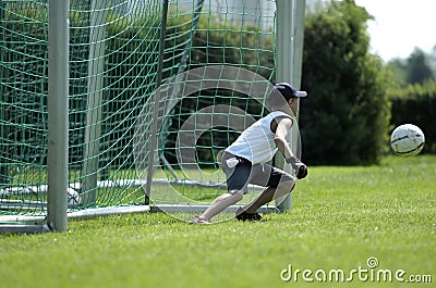 Boy as keeper at a soccer game Stock Photo