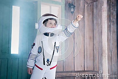 Boy in astronaut costume flying on porch Stock Photo