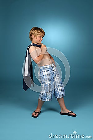 Boy in baggy blue plaid shorts Stock Photo