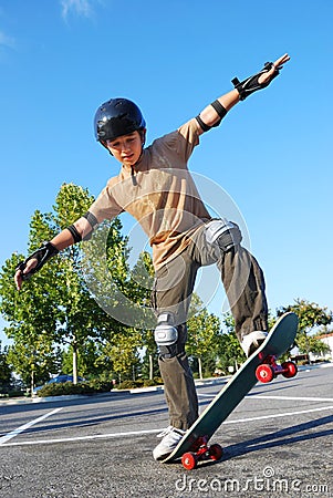 Boy Balancing on Skateboard Stock Photo