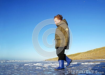 Boy at Beach in Winter Stock Photo